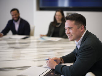 3 attorneys sitting at marbled conference room table